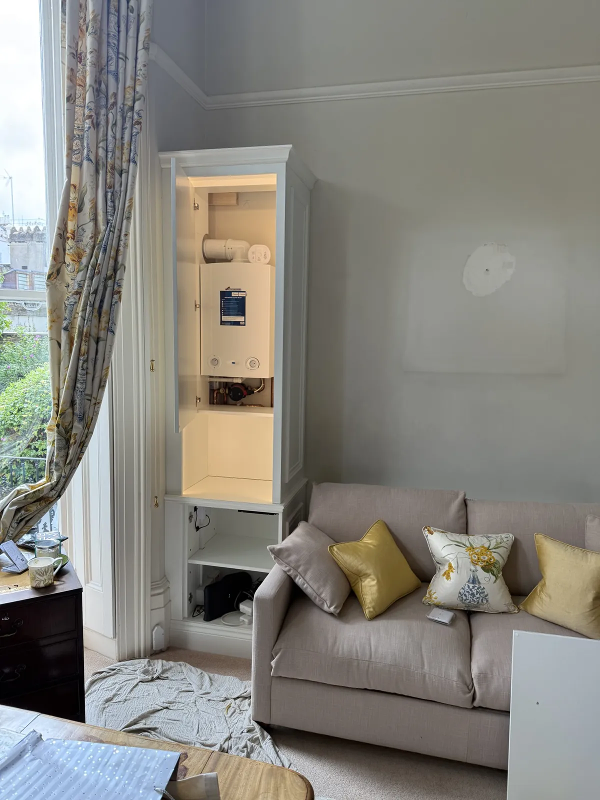 Boiler and pipework neatly housed in a bespoke fitted cupboard after installation